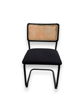 Cargar imagen en el visor de la galería, Chair with black upholstered seat and woven backrest on a white background
